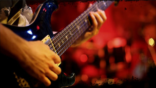 Guitarist blurry lights red background - a person playing free wallpaper