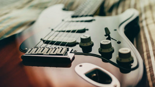 Guitar black body closeup knobs - a close up of a guitar free wallpaper
