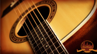 Guitar logo closeup brown background - a close up of a guitar free wallpaper