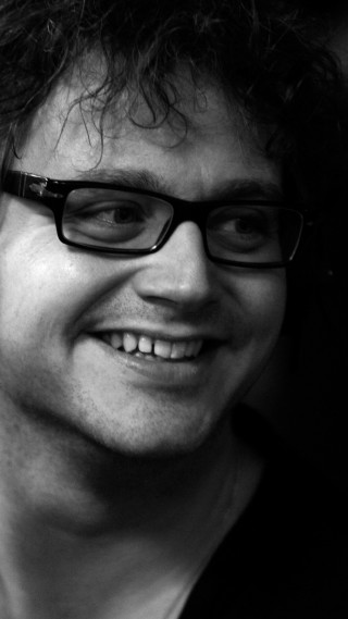 Man glasses smiling cellphone photorealism - glass free wallpaper
