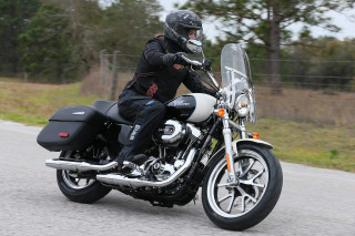 Man riding motorcycle street forest - dan scott free wallpaper