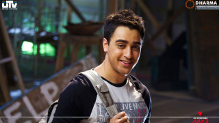Man backpack smiling camera green - a green light in the background free wallpaper