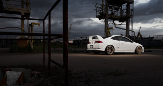 White car parking lot cloudy - a tower in the background free wallpaper