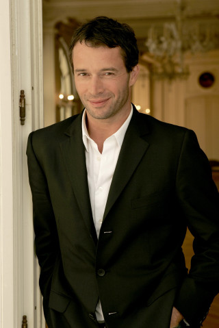Man suit doorway smiling camera - his hands in his pockets free wallpaper
