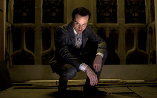 Man suit tie crouching window - dramatic free wallpaper