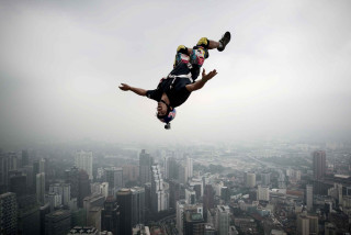 Man skateboard trick air cityscape - cliff childs free wallpaper