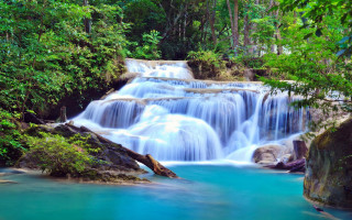 Waterfall blue pool trees people - a blue pool in the middle of it free wallpaper
