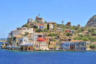 Small island houses boat water - side and a boat free wallpaper