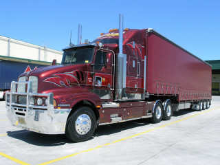 Red semi truck parking lot 2 - a red semi truck free wallpaper