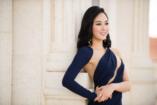 Woman blue dress leaning wall 6 - against free wallpaper