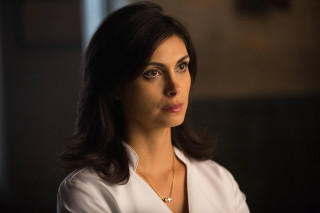 Woman white shirt serious look - free dark wallpaper