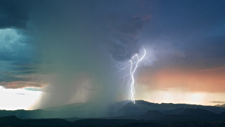 Lightning bolt hitting mountain sky - a mountain in the distance free wallpaper