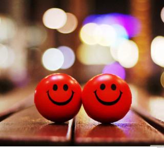 Two red balls with faces - a blurry background free wallpaper