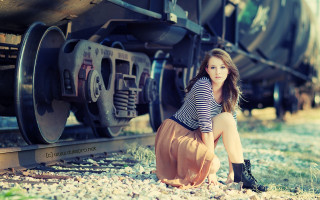 Woman sitting ground train car - a train free wallpaper