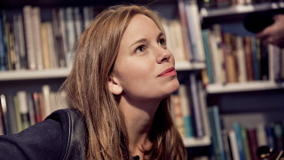 Woman looking up book shelf - book free wallpaper