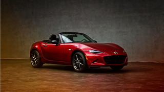 Red sports car dark room 104 - a white wall behind free wallpaper