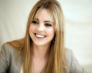 Woman blonde hair smiling gray - a photo free wallpaper