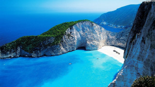 Beach rock formation water scenery 4 - a large rock formation in the middle of it free wallpaper