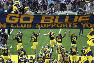 Football players banner holding girls - a poster free wallpaper
