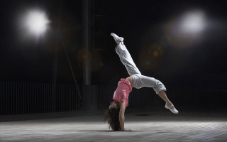 Woman handstand brick floor dark - a brick floor free wallpaper