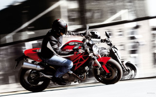 Man riding red motorcycle neoclassic - a black helmet free wallpaper