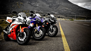 Motorcycles parked road mountain range 2 - a cloudy sky free wallpaper