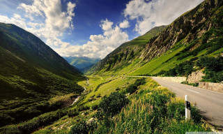 Scenic valley road mountains clouds 2 - a scenic view of a valley free wallpaper