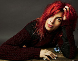 Woman red hair sweater pose - her head and a flower free wallpaper