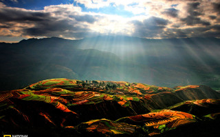 Mountain range sunshine clouds sunbeams - a view of a mountain range free wallpaper