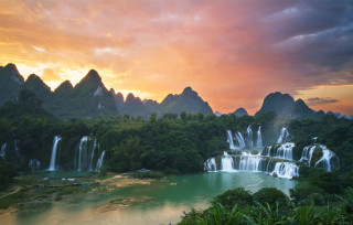 Sunset waterfall jungle river mountain - a mountain range in the background free wallpaper