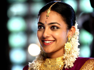 Woman gold flower necklace smile - movie still frame free wallpaper