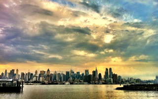 City skyline cloudy sky water 2 - a boat in the foreground free wallpaper