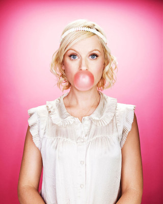 Woman blowing bubble pink background - free happy birthday wallpaper