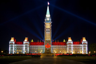 Nighttime building clocktower lights flag - free new year wallpaper