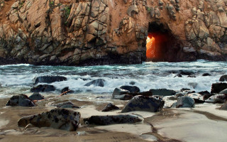 Cave entrance red light ocean - land art free wallpaper
