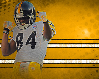 Football player holding ball yellow - his right hand free wallpaper