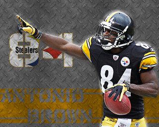 Football player holding ball pointing 2 - a football player holding free wallpaper
