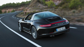 Black porsche sports car mountain 2 - a mountain in the background and trees free wallpaper