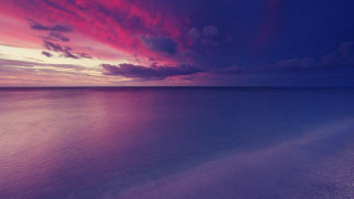 Pink purple sunset ocean boat - the water and a boat in the foreground free wallpaper