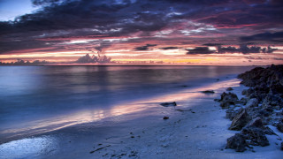 Beach rocky cliff water cloudy - sunset free wallpaper