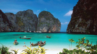 Beach boats mountain blue sky - the water and a mountain in the background free wallpaper