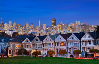 Houses city skyline nighttime view - a green lawn in front free wallpaper