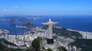 Christ statue overlooking city ocean 4 - blue sky free wallpaper