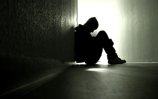 Person sitting dark room feet 3 - somber free wallpaper