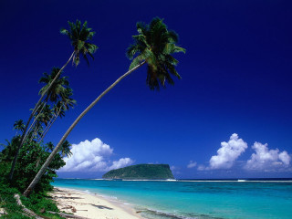 Beach palm tree island clouds - a small island in the distance free wallpaper