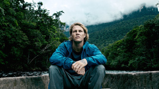 Man sitting wall river mountains - the background and a forest free wallpaper