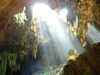 Cave light person green jacket - a cave free wallpaper
