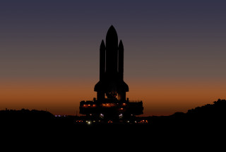 Large building rocket night sky - a few light free wallpaper