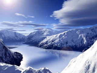 Snow covered mountain lake cloudy - a lake in the middle of it free wallpaper