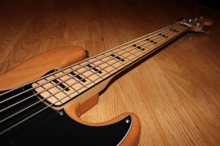 Guitar closeup wooden surface black - matte finish free wallpaper